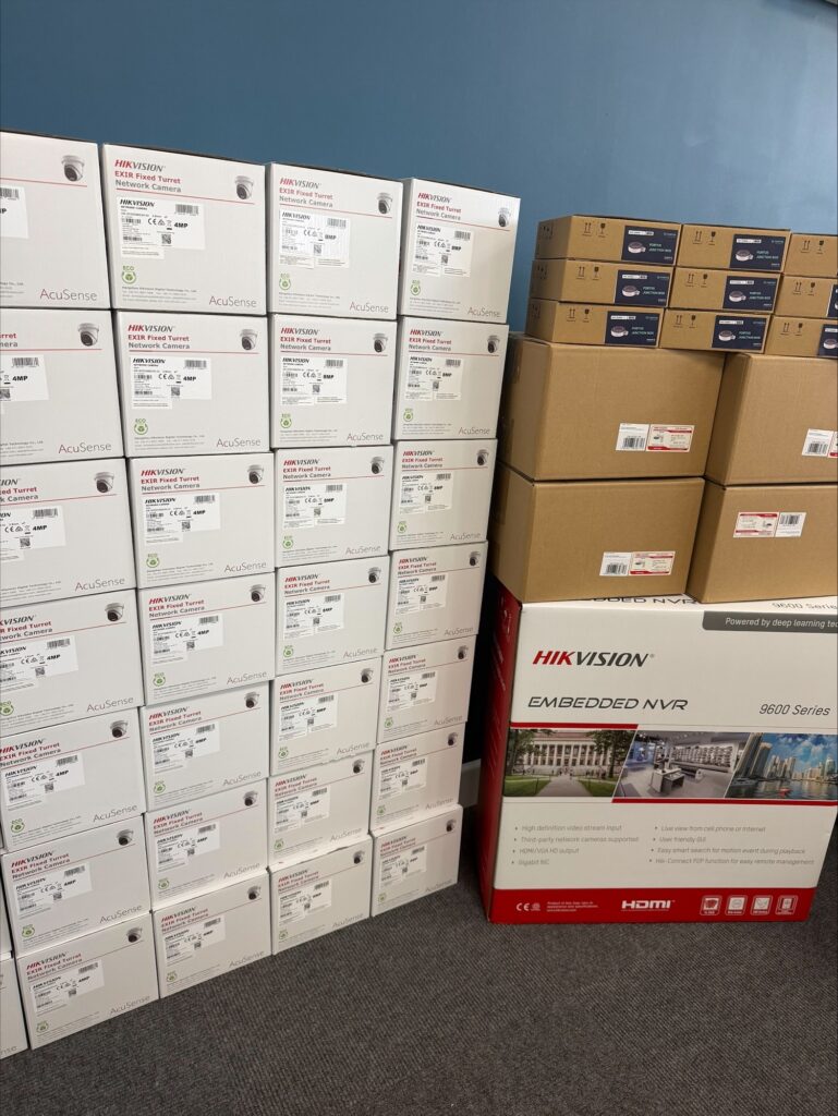 Boxes of Hikvision CCTV cameras & a 64-channel NVR ready for installation at a large school site.