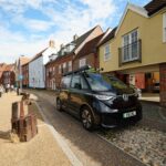 Black LVL1 Volkswagen ID. Buzz parked on a historic street in Norwich