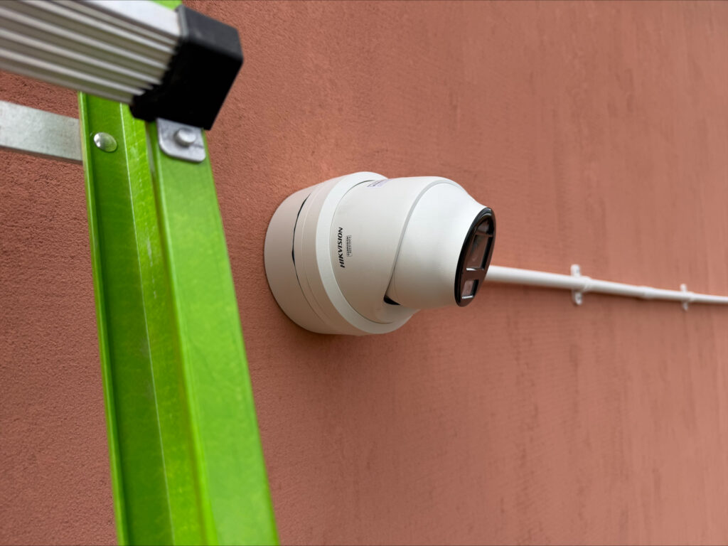 New Hikvision turret CCTV camera mounted neatly on an external wall with surface-mounted cabling.